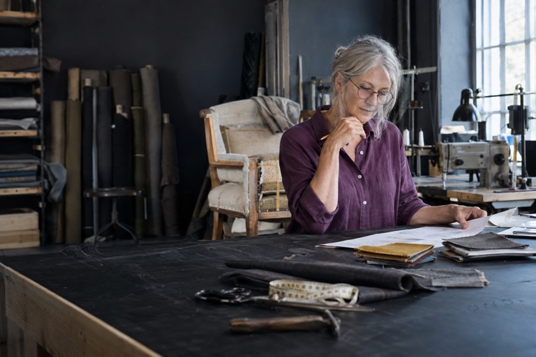 Workshop owner reviewing an order at her bench